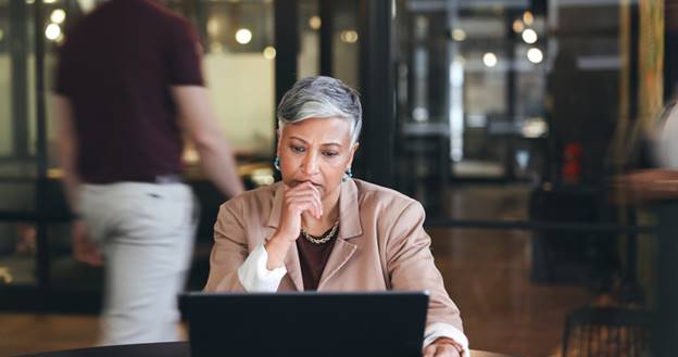 Woman nervous sitting at laptop - Age Discrimination